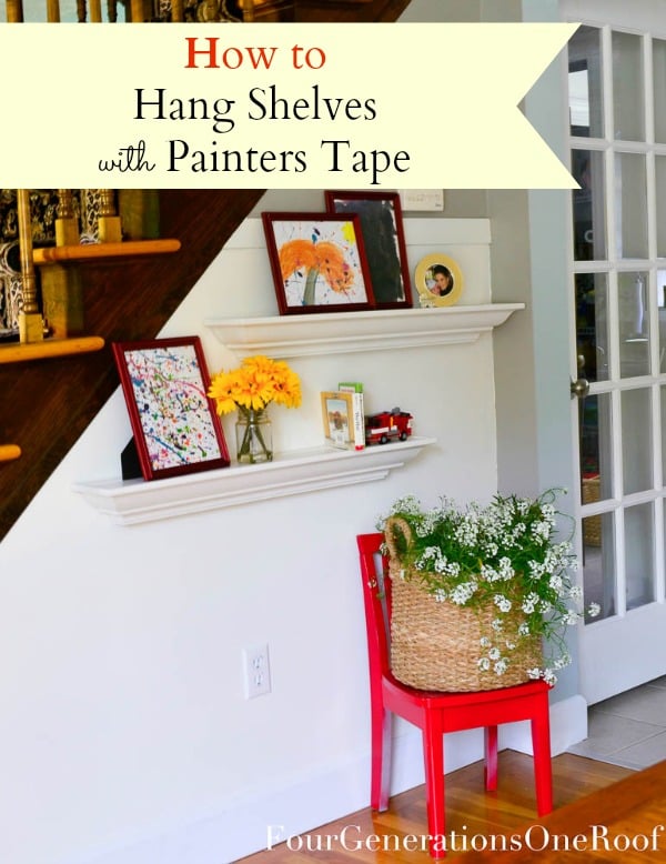 white floating shelves hanging on wall with kids framed artwork red chair and plant