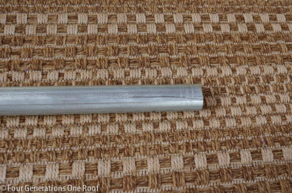 galvanized pipe on outdoor brown tweed rug 