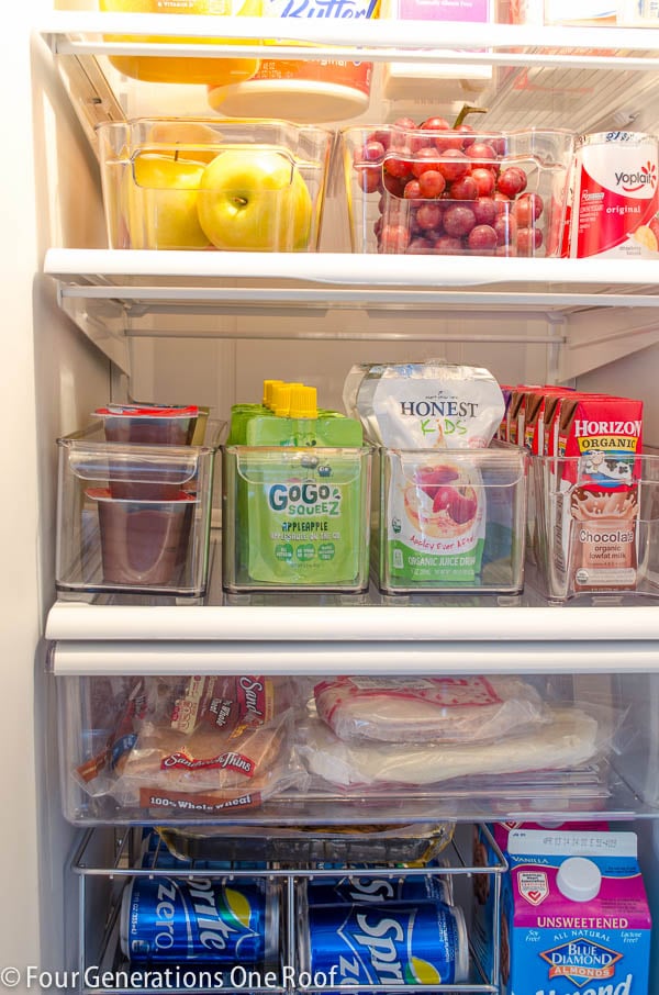 Clean refrigerator with plastic pull out bins for snacks, drinks and fruit