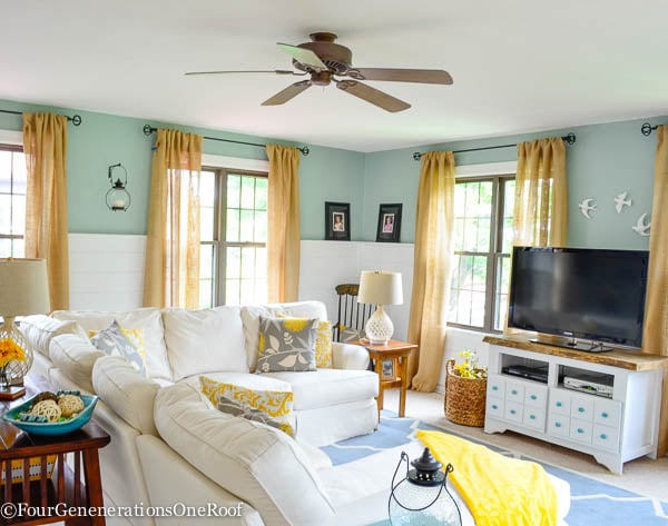 blue and white living room, burlap curtains, clean windows, blue rug 