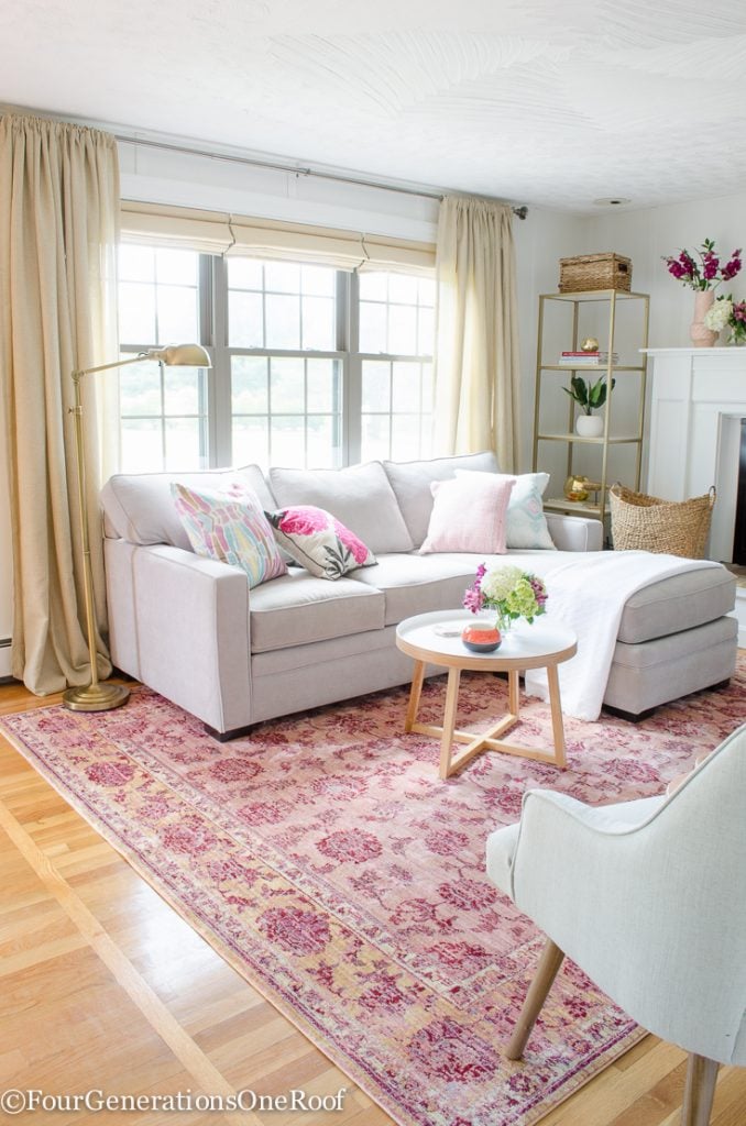 Sectional living room layout with chaise against wall, navy and coral accents, positioned near fireplace for easy access