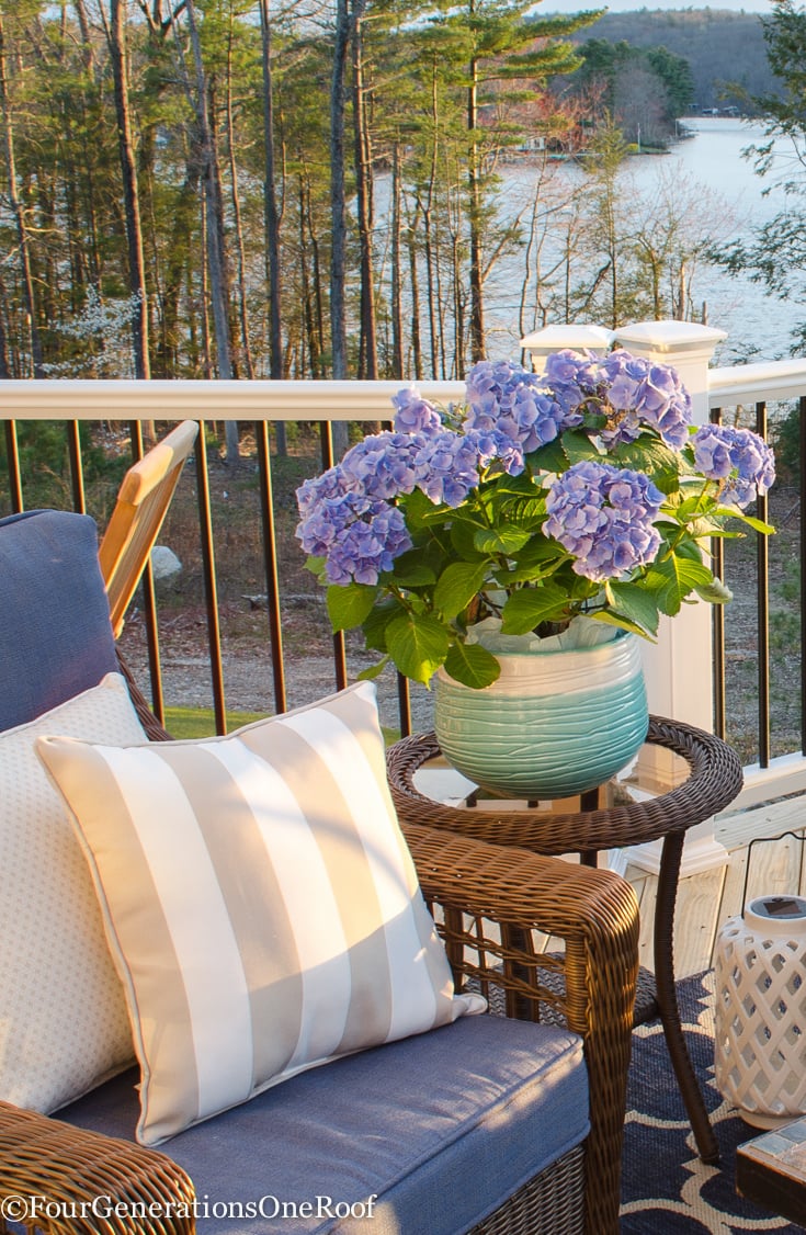 Snag Patio Furniture Under 0 {LakeSide Deck Reveal} How to create a cozy patio or deck space with affordable wicker furniture, lots of ceramic planters and a gorgeous firepit for ambiance. #patiofurniture #patio #deckfurniture #wickerfurniture #outdoors #outdoorfurniture #curbappeal #lakeliving #decor #decorating #exterior #outdoorseating