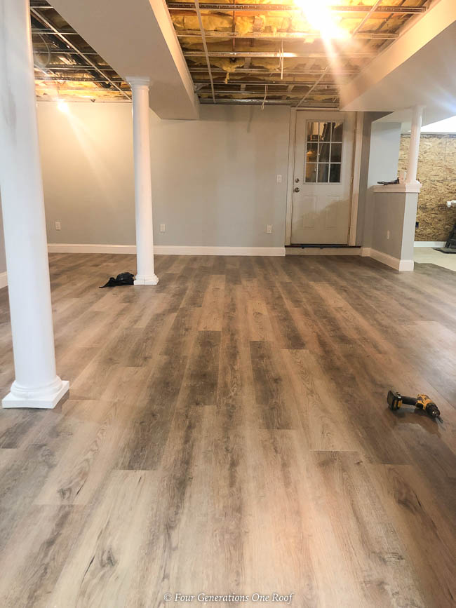 Harvest Oak Rigid Core Vinyl Flooring, Sherwin Williams Lullabye paint and white lally columns