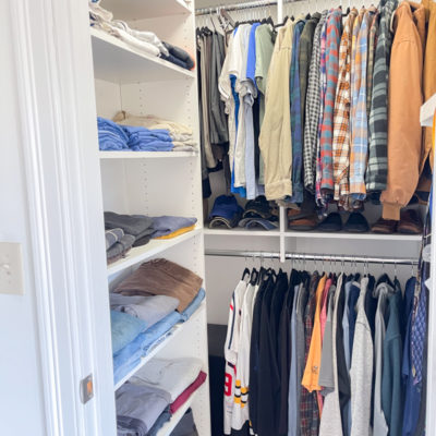 walk in closet with white wood shelves and hanging rods