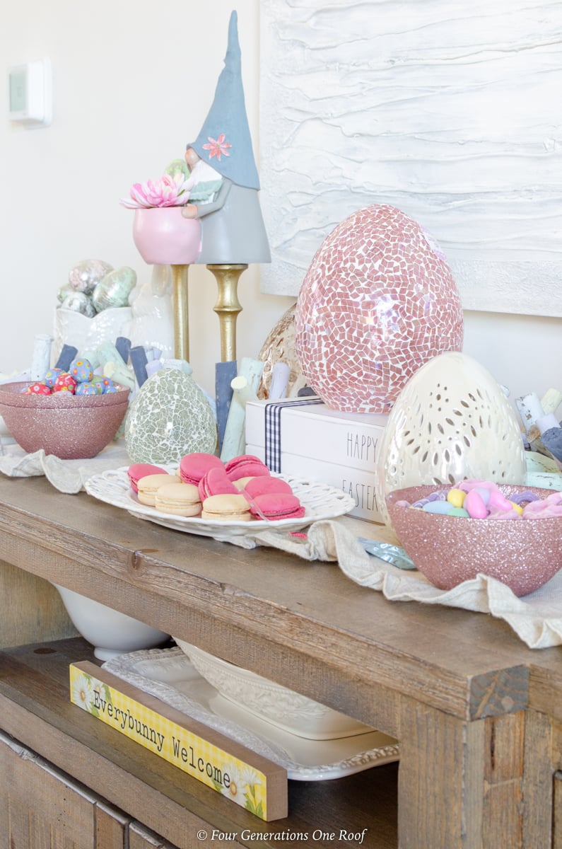 Easter Dining Room Decorating Ideas with bunny station - pink glass Easter eggs, white ceramic easter eggs, gold candlesticks, Easter gnomes, Easter candy