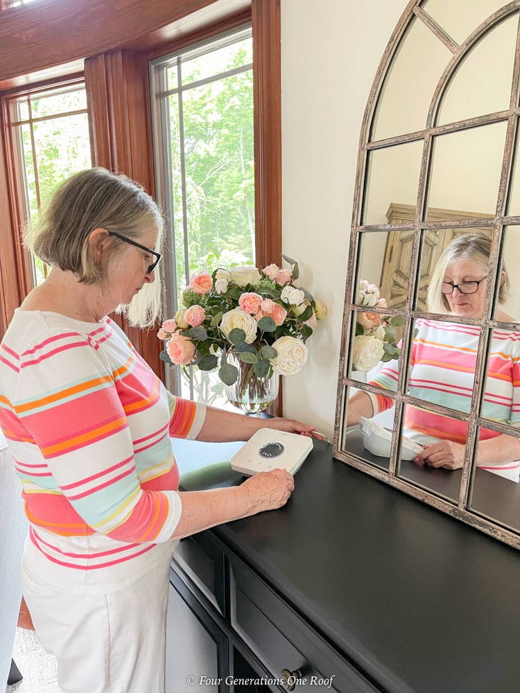 getsafe medical alert and 70 year old woman setting up device on table