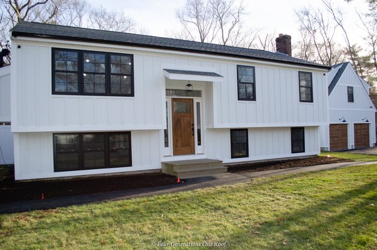 white board and batten split level with black windows