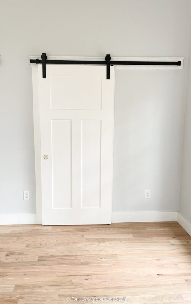 white 3 panel interior door on black sliding barn door hardware 