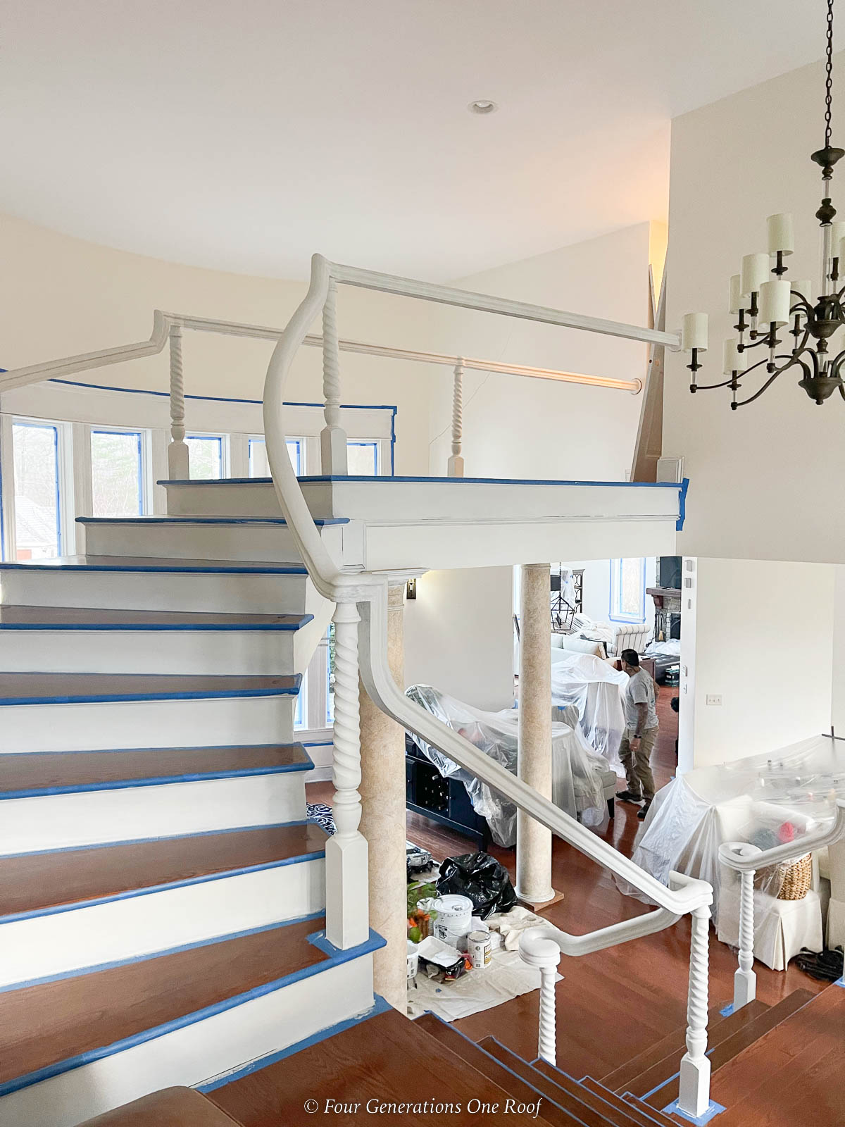taping off stair risers with blue painters tape and painting white