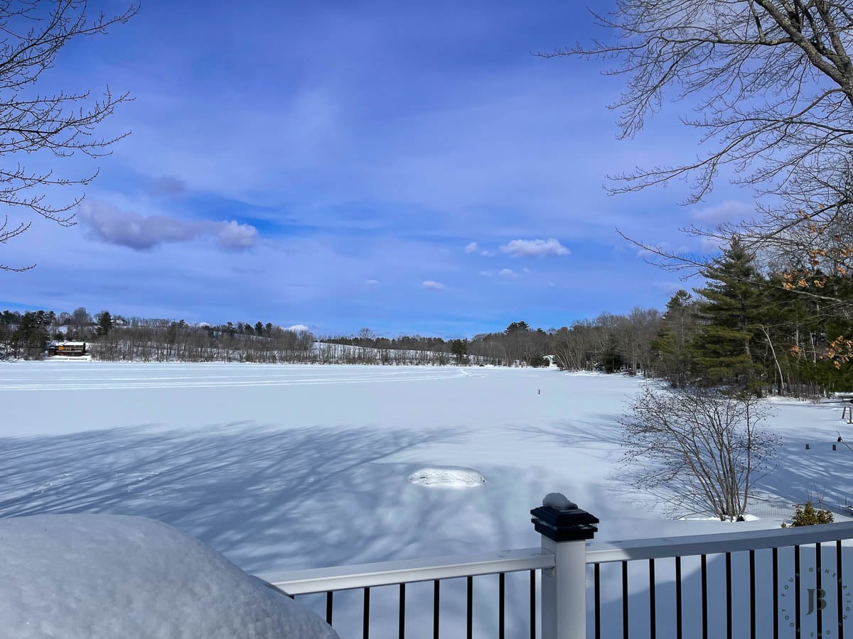 snow covered lake house Airbnb vacation rental in New Hampshire with direct waterfront access and private dock