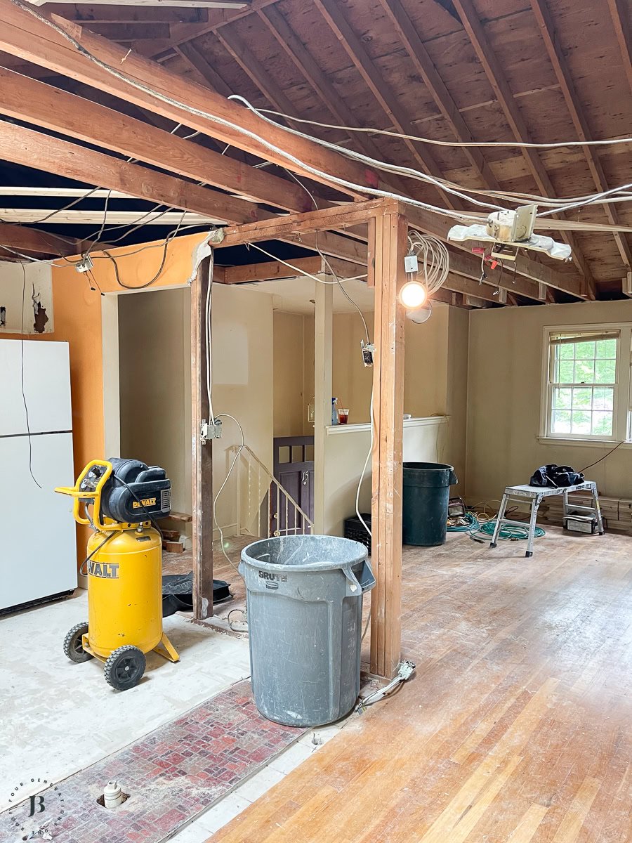 installing a load-bearing beam between a kitchen and living room to create an open-concept space