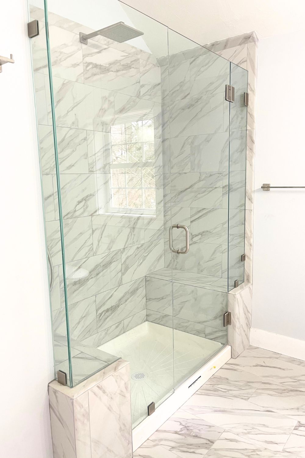 walkin shower bathroom remodel with large scale white and gray tile with glass doors