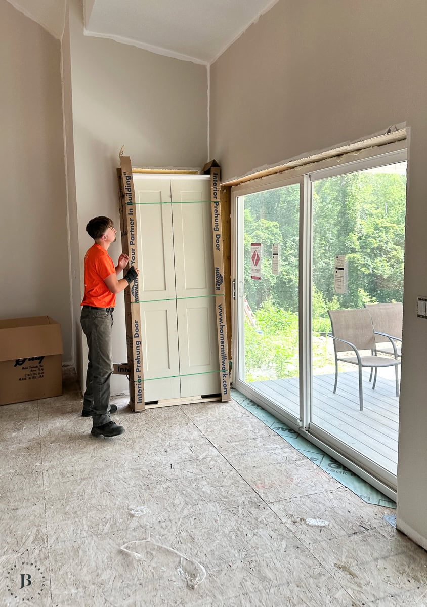 Horner Millwork prehung white interior doors with black hardware securely wrapped for delivery to job site