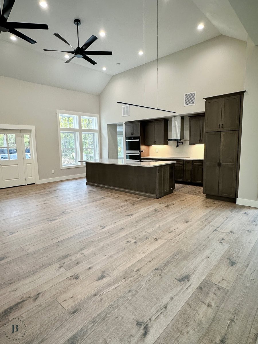 Two houses connected shared kitchen with dark brown cabinets and quartz countertops in multigenerational home