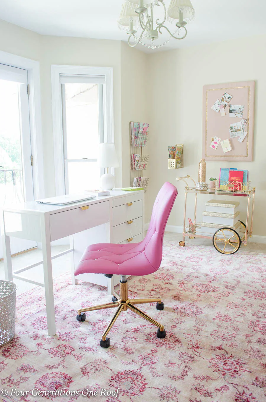 Organized pink and gold office showing wall storage and desk organization systems