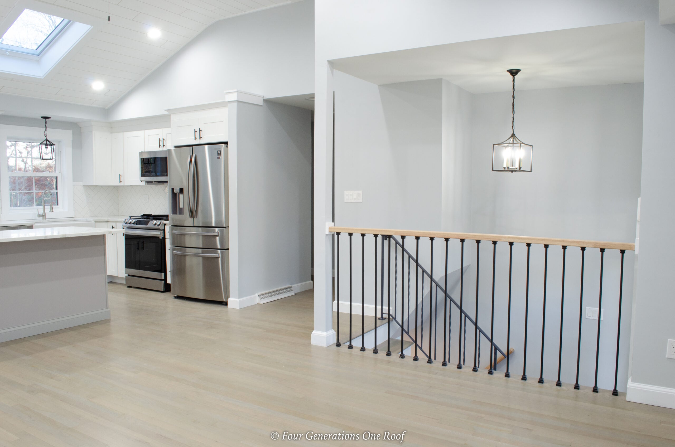 modern split level white kitchen with skylights 