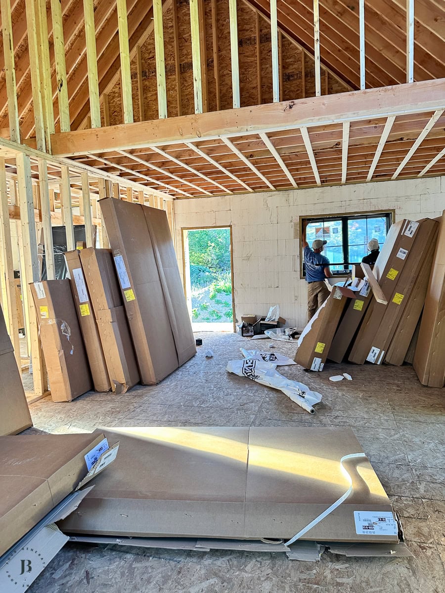 The interior framing in progress. You can see the ceiling joists exposed, drywall staged and leaning against the walls waiting to go up. The ICF wall texture is visible on the exterior walls &mdash; that&rsquo;s the foam insulation that stays as part of the wall system. This is what a working job site looks like between before and after.