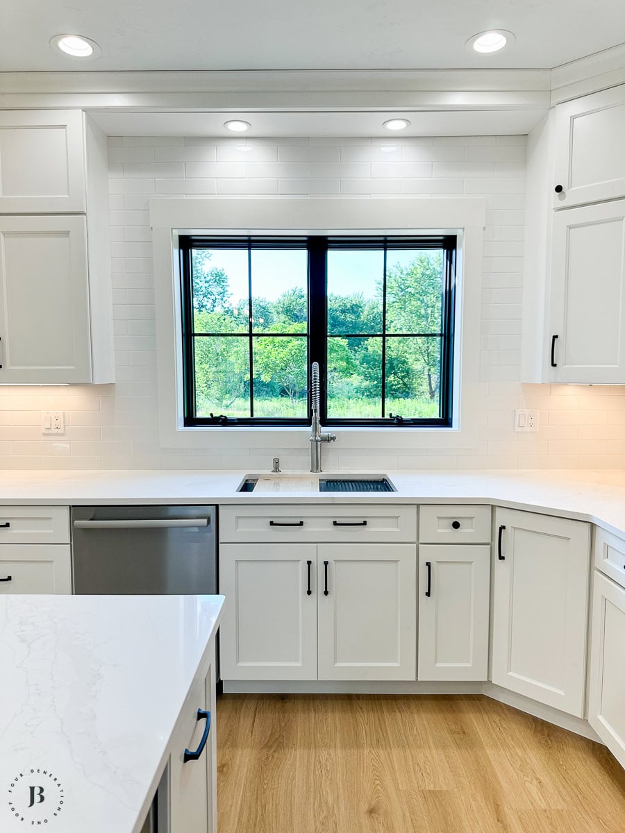 Finished 900 sq ft multigenerational ADU, real small ADU floor plan ideas in action - kitchen sink and white cabinets