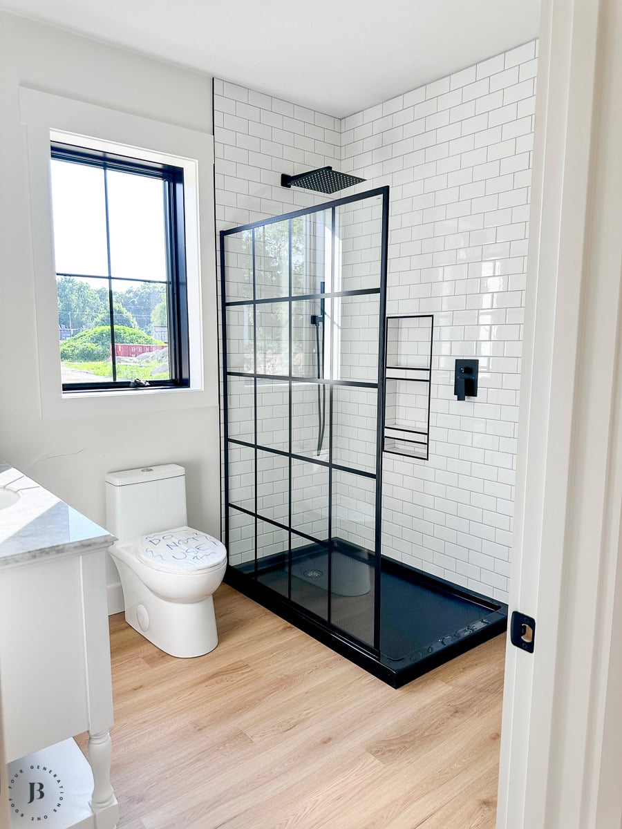 Finished 900 sq ft multigenerational ADU, real small ADU floor plan ideas with large walk in shower bathroom with subway tile and glass wall