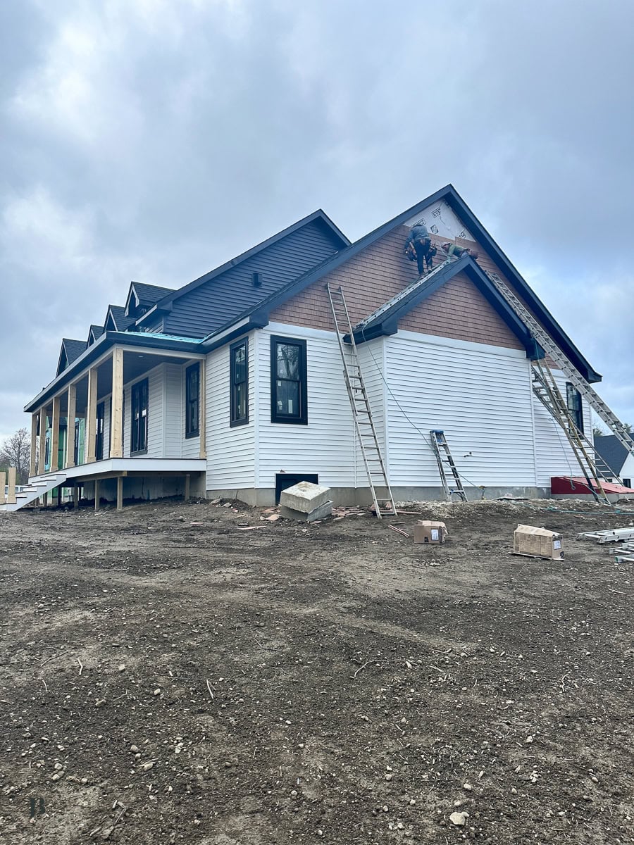 main house exterior showing mixed siding textures and colors underway