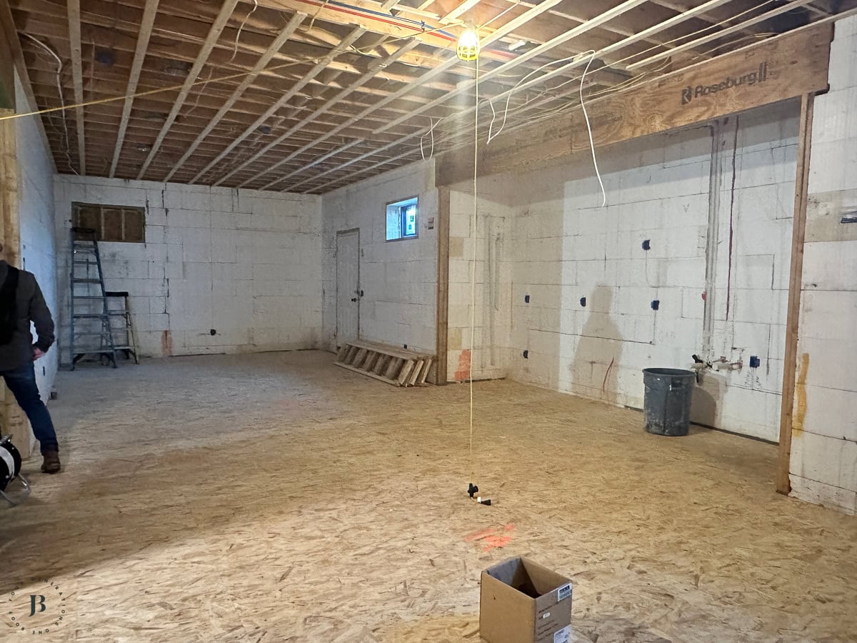 framed basement space where the bar and golf simulator area will go
