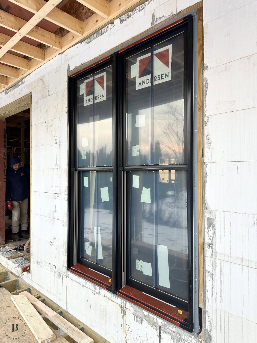 black Andersen windows on the main house's mixed-material exterior