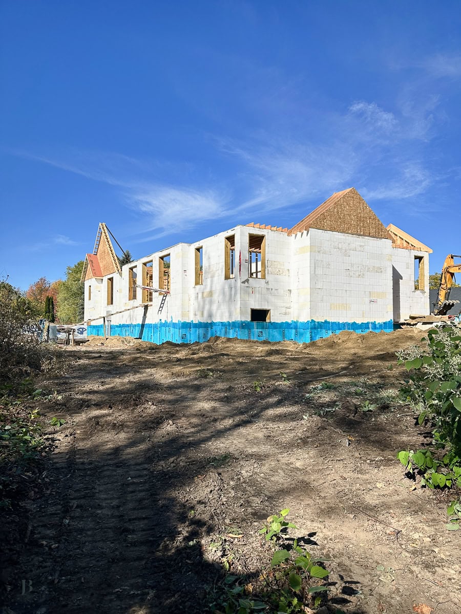 main house exterior with the roof completed and enclosed before winter snowfall