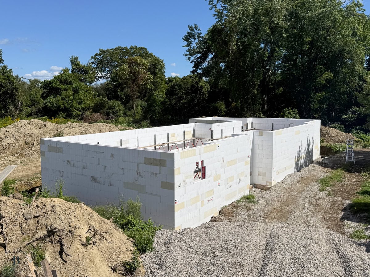 concrete pump truck boom reaching over ICF walls during the wall pour