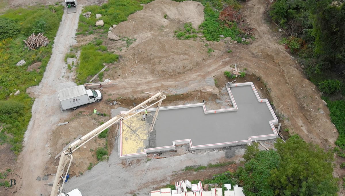 spray foam insulation covering the foundation area ahead of the concrete slab pour
