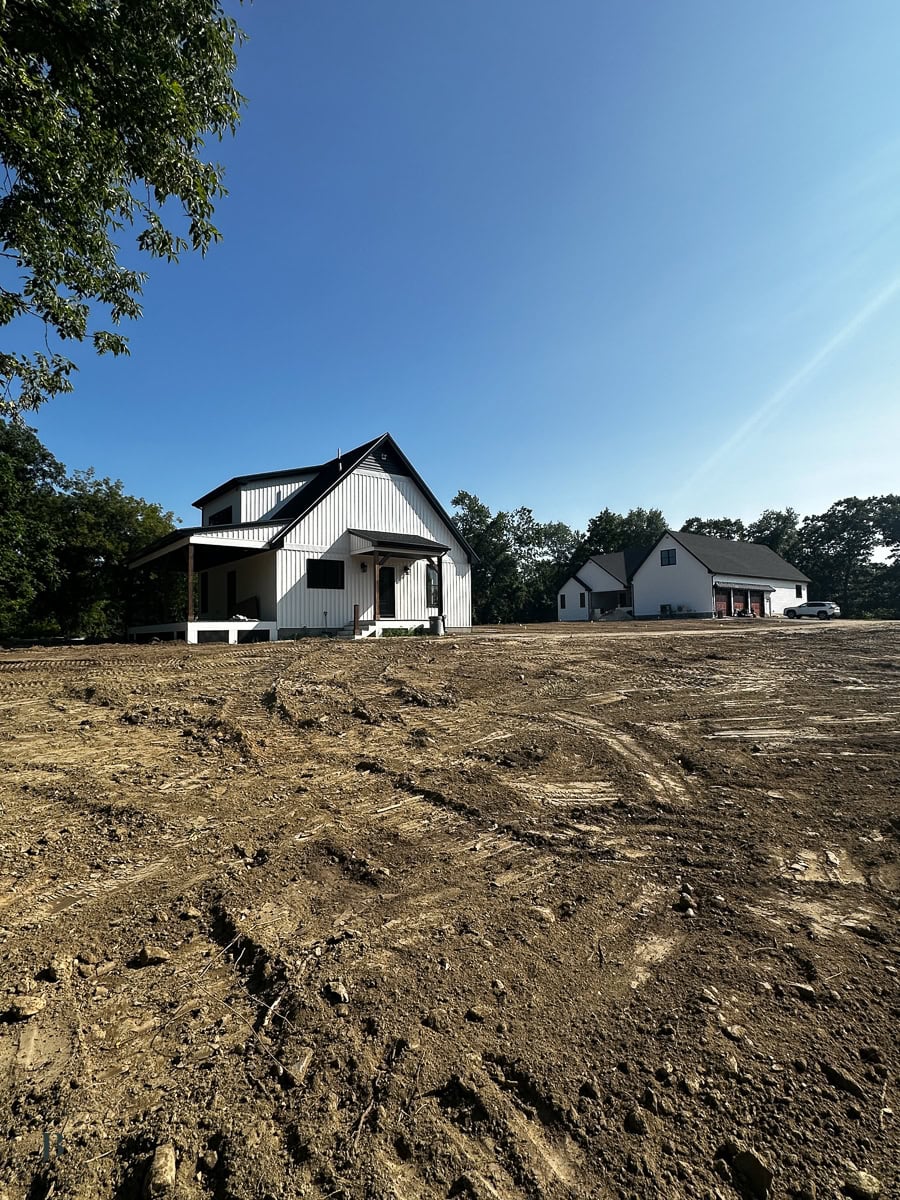 two houses on one property with the large main house at the front of the lot and the 900 square foot ADU towards the back of the property near woods