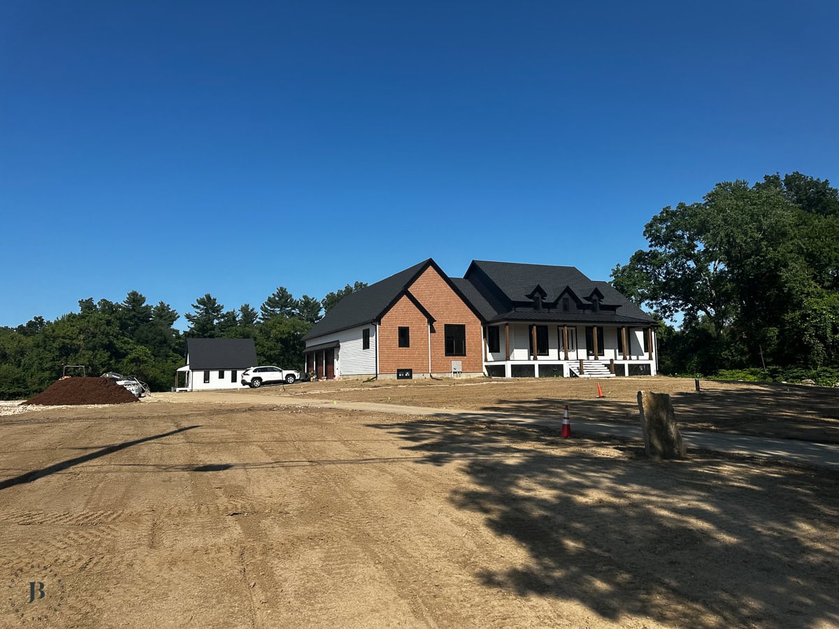 two houses on one property with the large main house at the front of the lot and the 900 square foot ADU towards the back of the property near woods