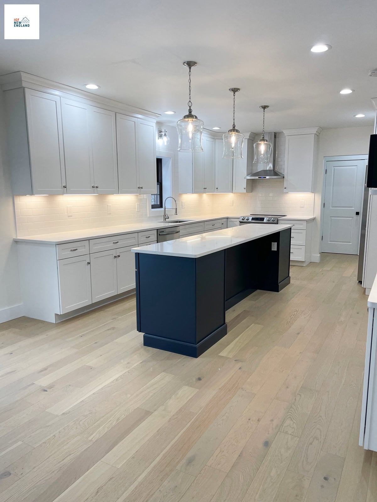 Long, narrow kitchen island with seating, cabinets built on both sides of the wall