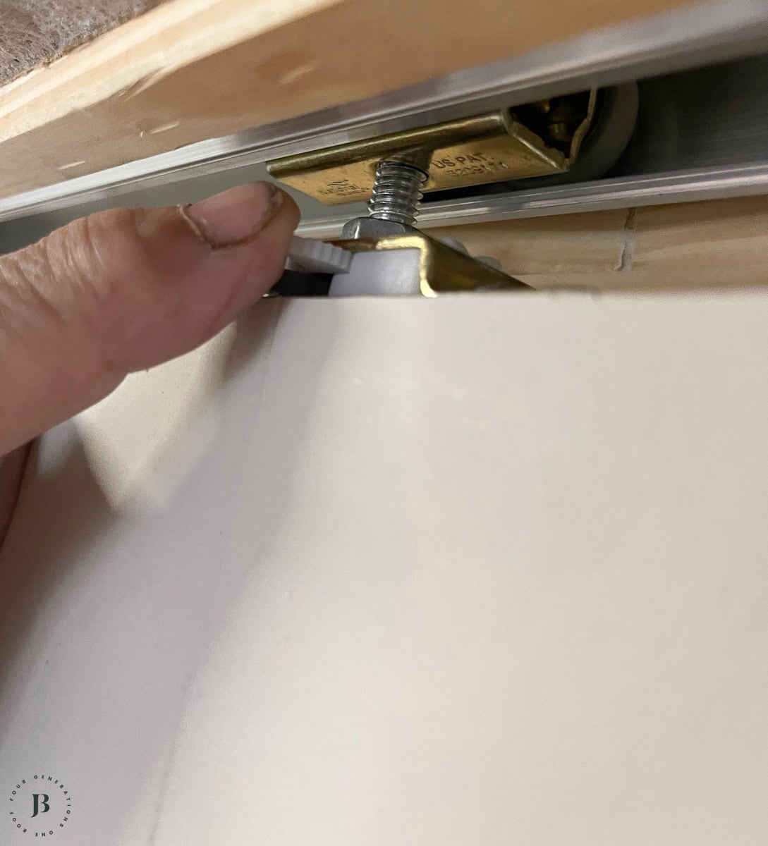 adjusting pocket door hardware on the top of the door slab