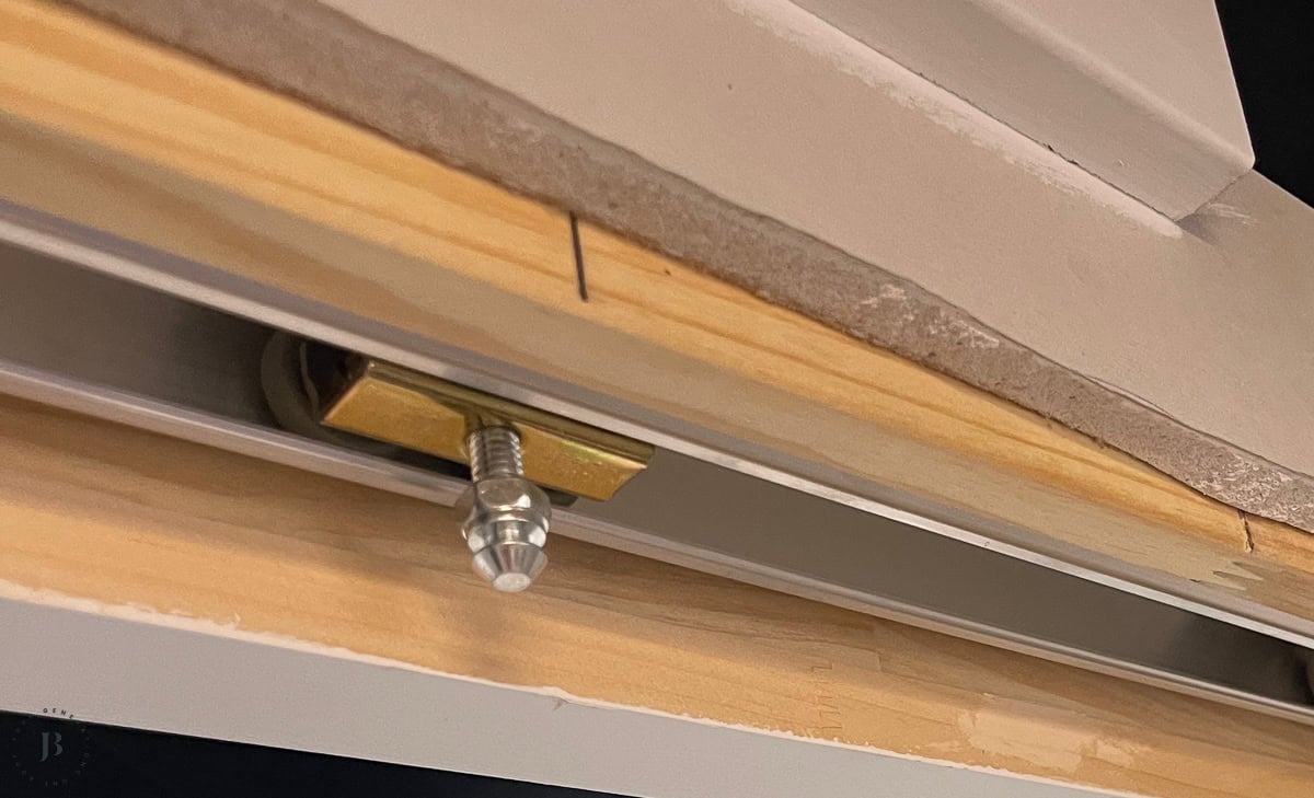 pocket door hardware track attached to top of door frame